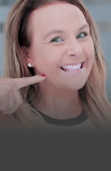 Close-up of a patient smiling brightly, showcasing their dental implants.